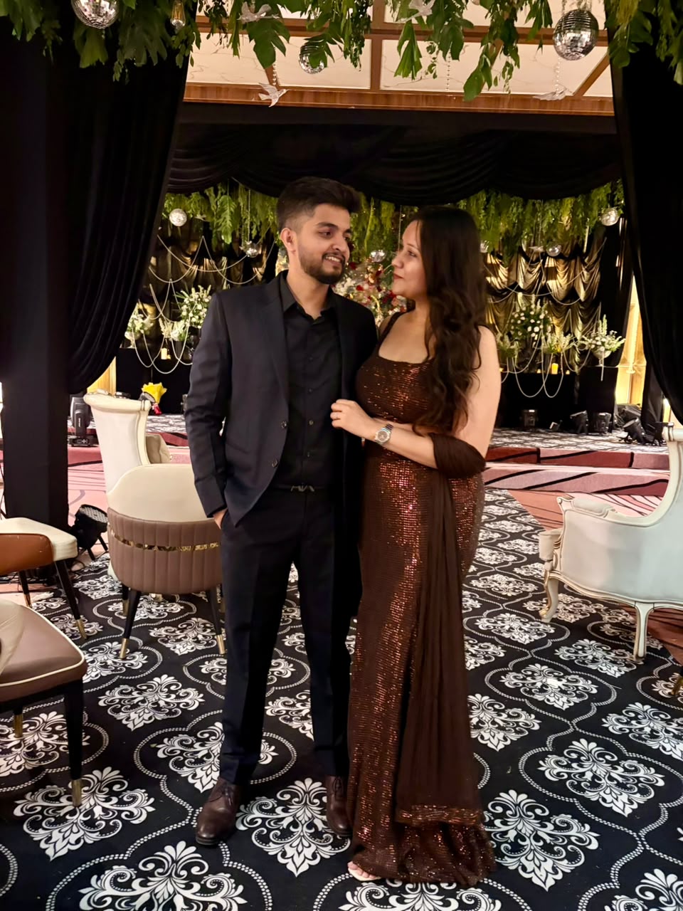Couple in brown sequin gown at the reception