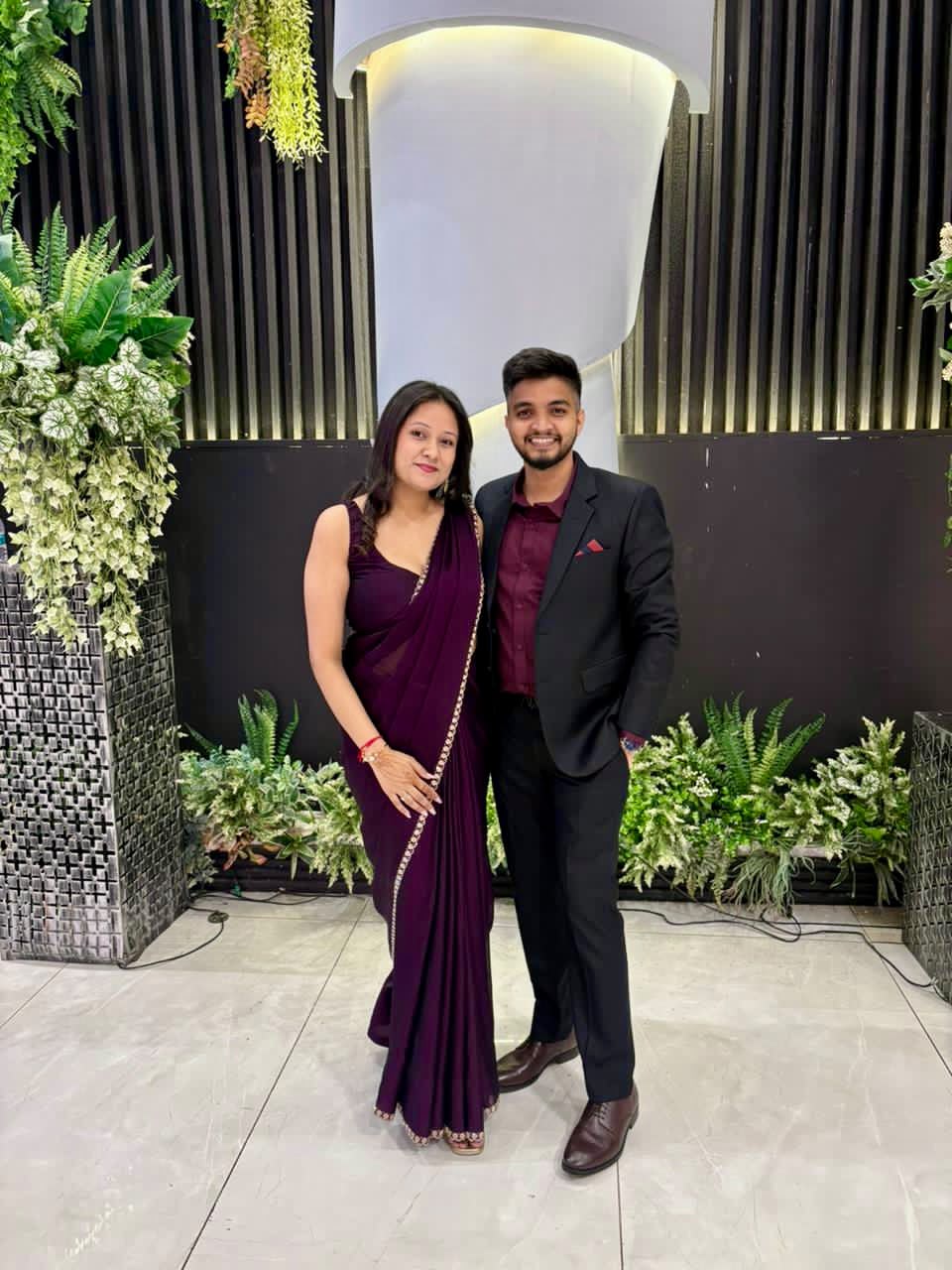 Couple in maroon saree and black suit